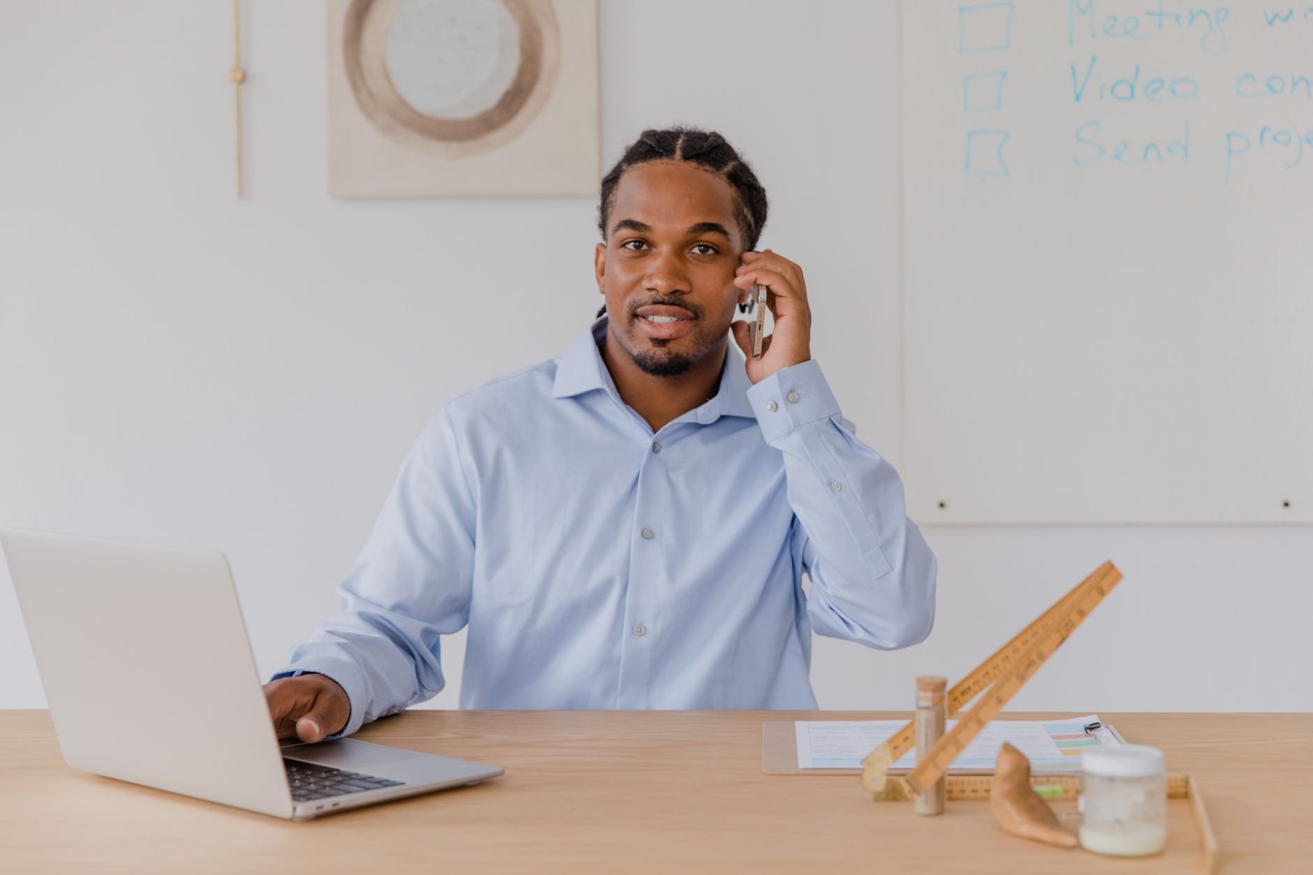 Small business owner at their desk, working confidently on a laptop in a warm, professional office